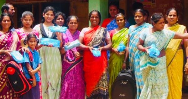 care and love foundation volunteer distributing sanitary pads to village women